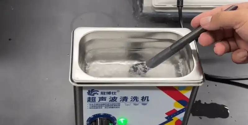 Makeup brushes being cleaned by an ultrasonic cleaner
